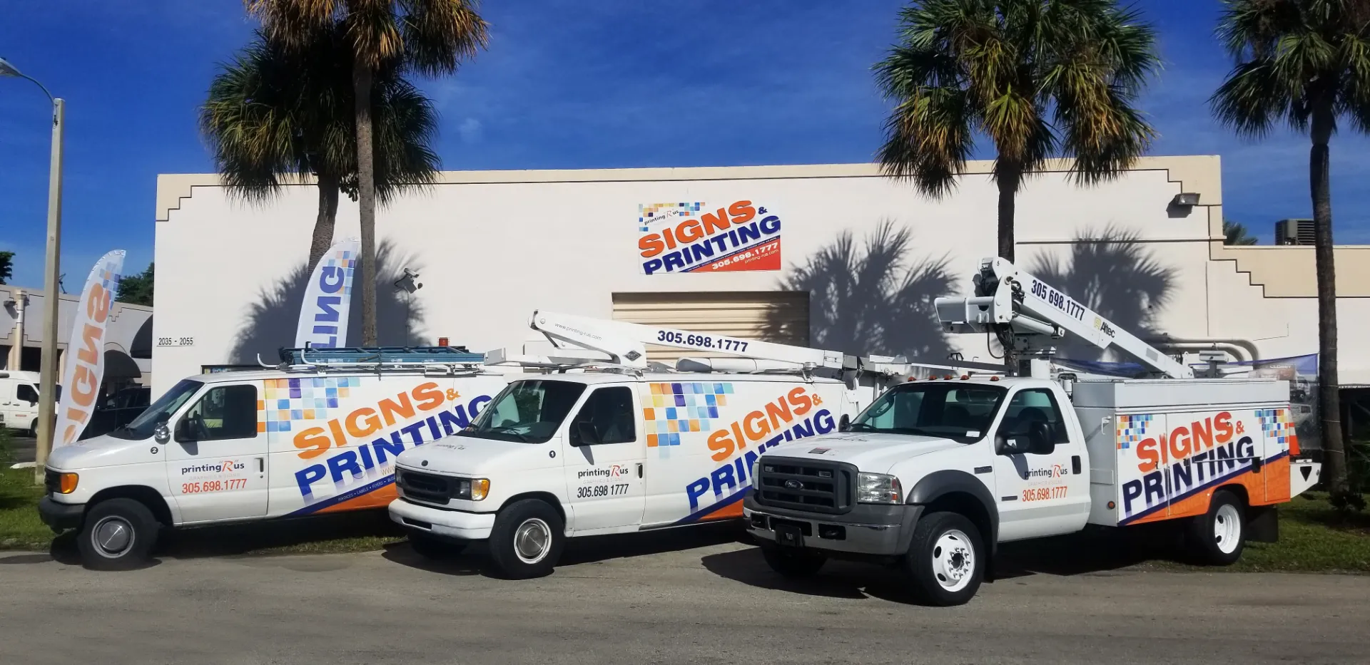 Printing R Us wrapped fleet vehicles outside the Hialeah sign and print shop